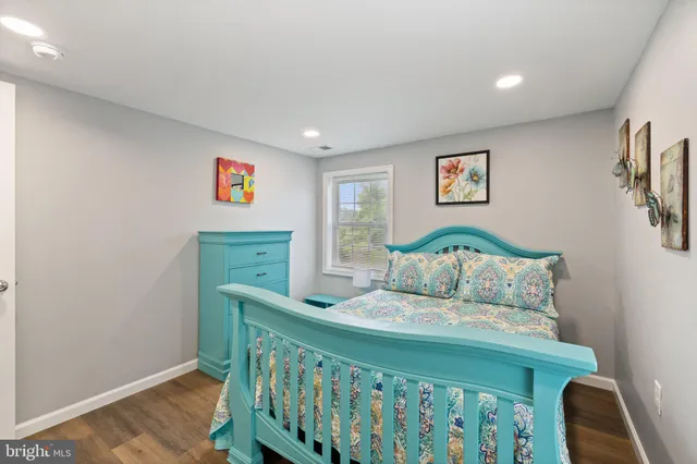 a white toilet sitting next to a white sink and a shower curtain