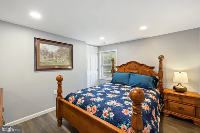 a bedroom with a bed and a dresser with mirror