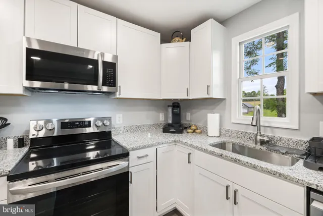 a view of a deck with a table and chairs with wooden floor and fence