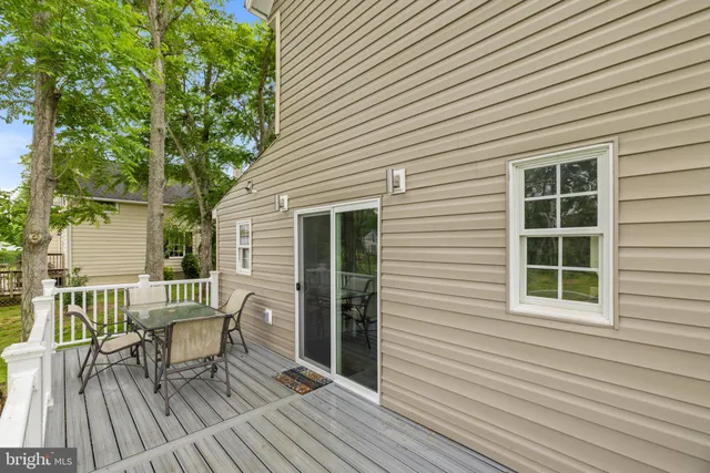 a view of a house with a yard and tree s