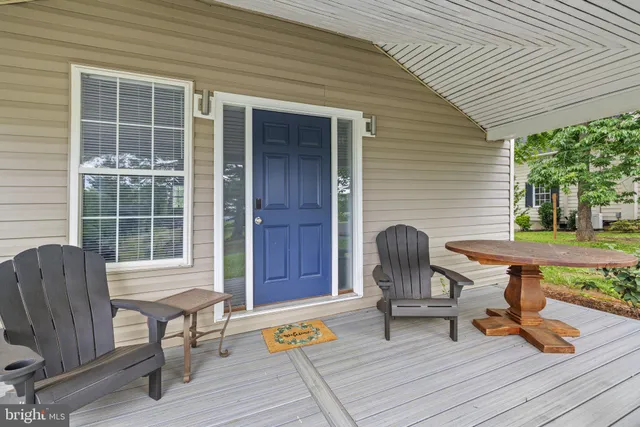 a view of a patio with table and chairs next to a yard