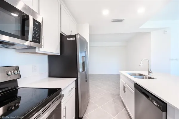a kitchen with stainless steel appliances granite countertop a sink and a stove