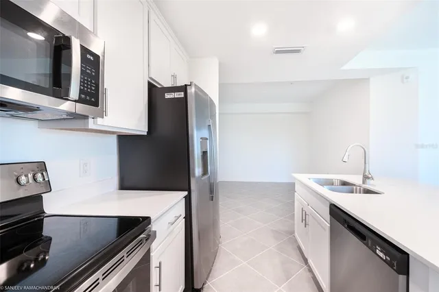 a kitchen with stainless steel appliances granite countertop a sink and a stove