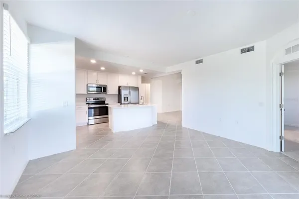 a view of kitchen with furniture and refrigerator