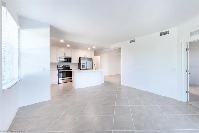 a view of kitchen with furniture and refrigerator