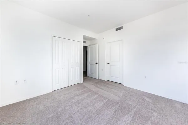 a living room with furniture flowerpot and wooden floor