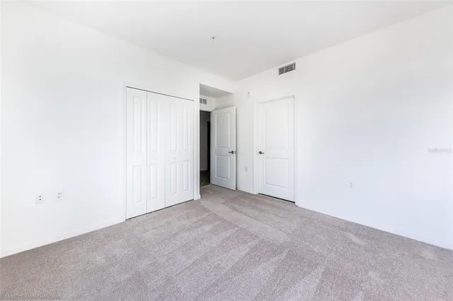 a living room with furniture flowerpot and wooden floor