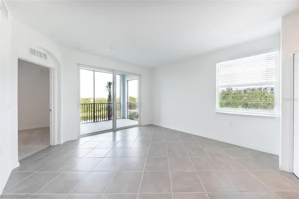 an empty room with windows and outdoor view