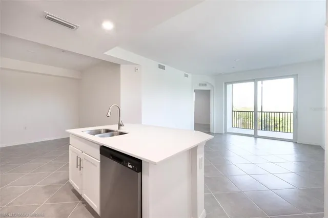 a spacious bathroom with a sink a vanity and a mirror