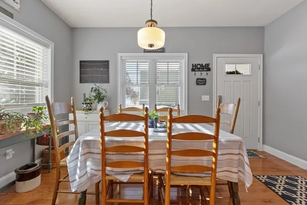 a view of a dining room with furniture and wooden floor
