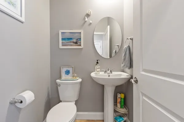 a bathroom with a toilet a sink and a mirror