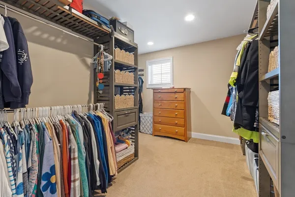 a view of walk in closet with clothes