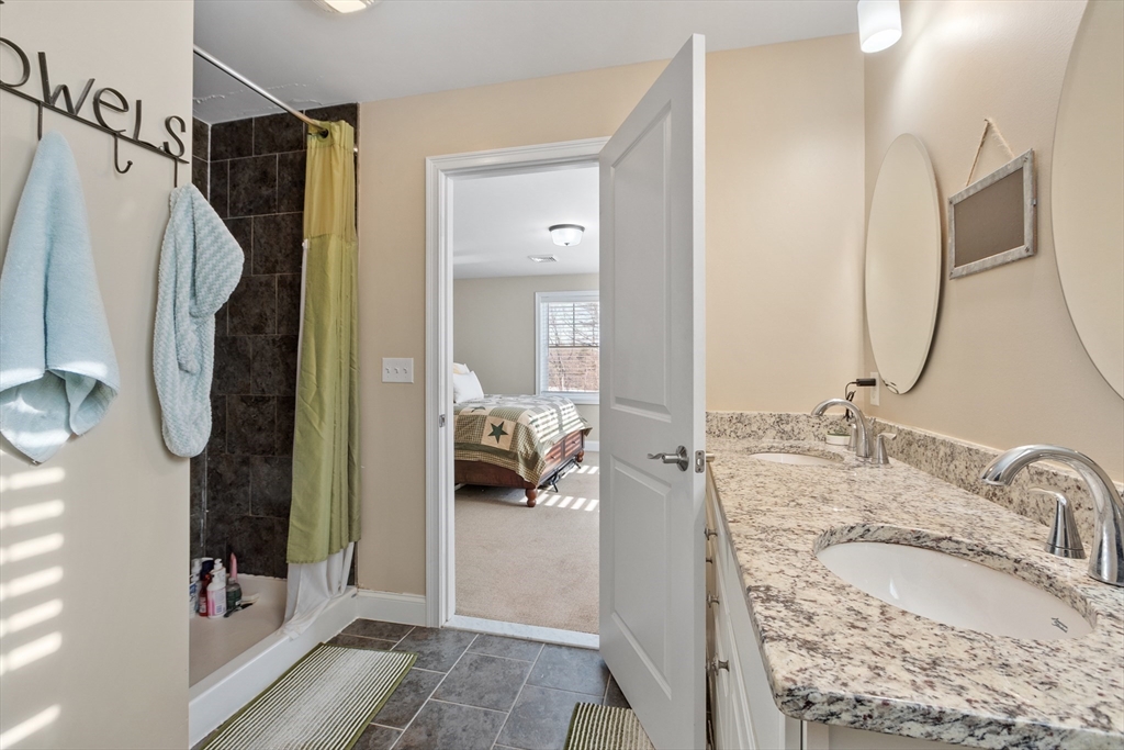 2 Eagle Nest Road, Unit B62 Clinton, MA 01510 - Photo 22 of 35 a en suite bathroom with a granite countertop double vanity sink mirror and shower