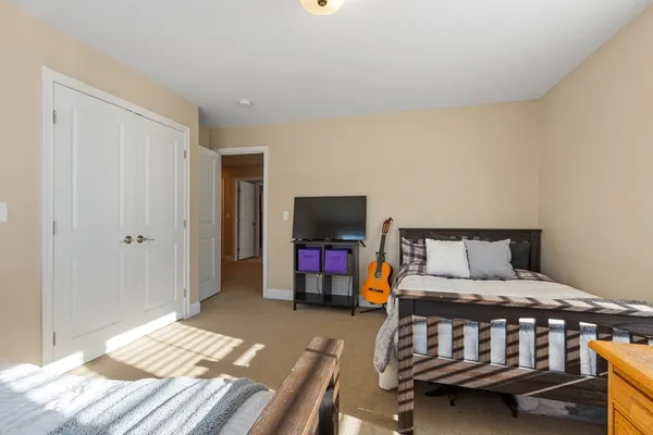 a bedroom with two beds and large window