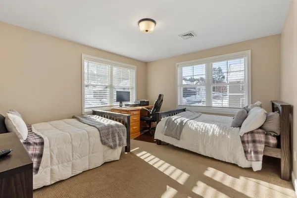 a bedroom with bed and a window