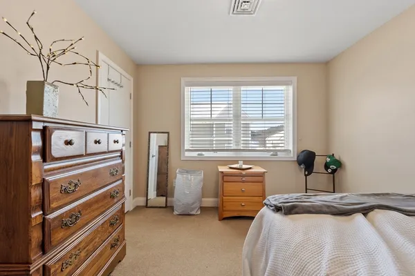 a bed sitting in a bedroom next to a window