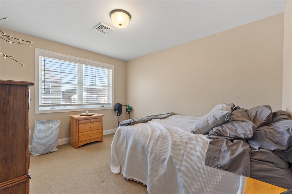 2 Eagle Nest Road, Unit B62 Clinton, MA 01510 - Photo 27 of 35 a bed sitting in a bedroom next to a window