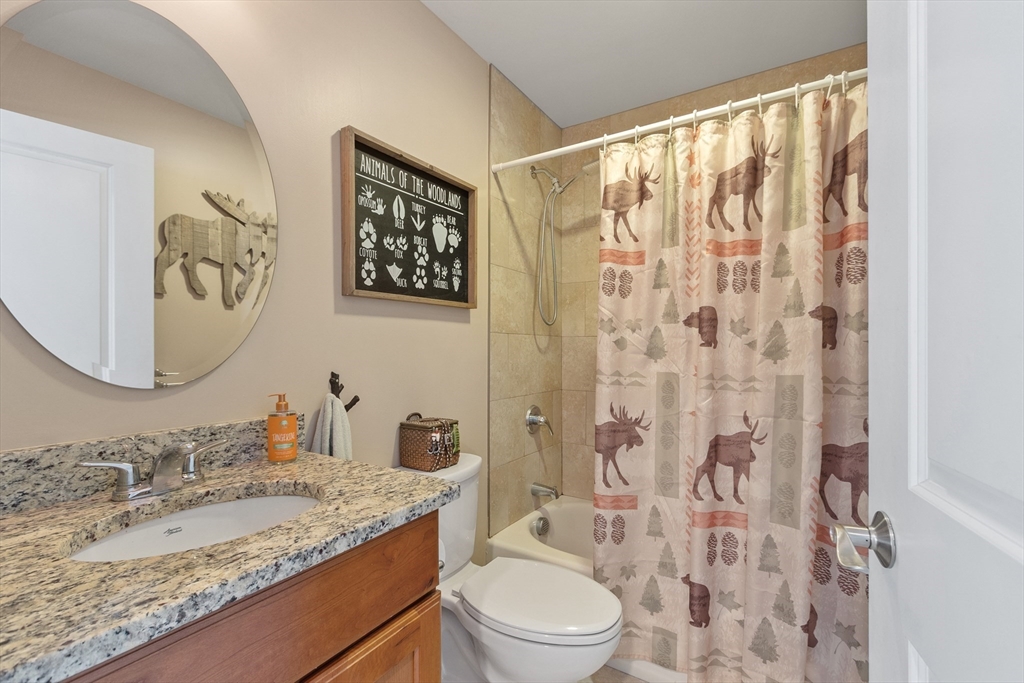 2 Eagle Nest Road, Unit B62 Clinton, MA 01510 - Photo 28 of 35 a bathroom with a granite countertop sink and a mirror