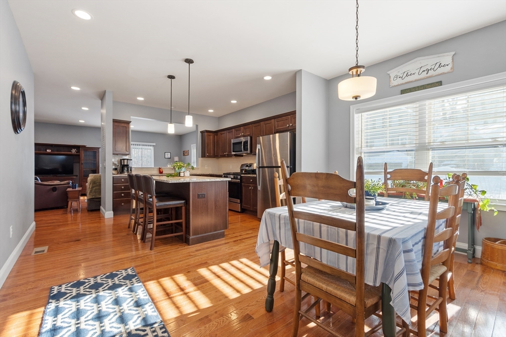 2 Eagle Nest Road, Unit B62 Clinton, MA 01510 - Photo 3 of 35 a kitchen with stainless steel appliances kitchen island granite countertop a dining table chairs and stove top oven