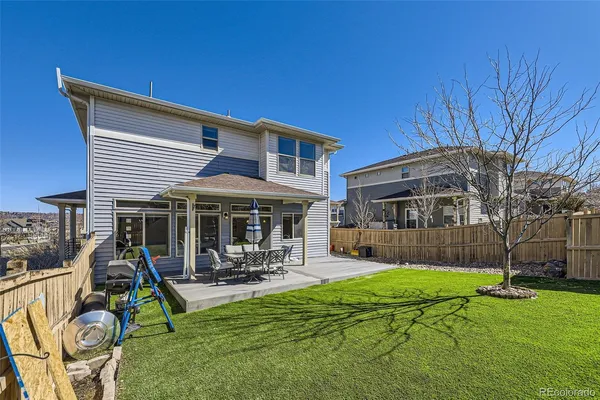 a view of a patio with couches chairs and a big yard