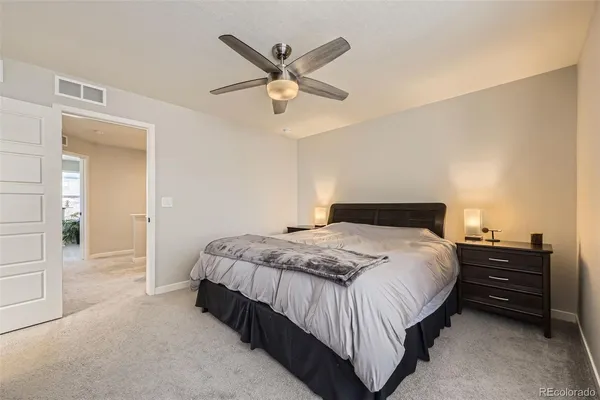 a bedroom with a bed and ceiling fan