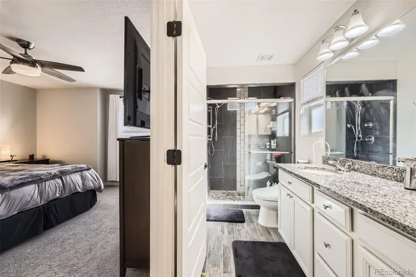 a spacious bathroom with a double vanity sink a mirror and shower