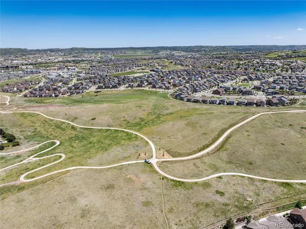 an aerial view of residential houses with outdoor space and swimming pool