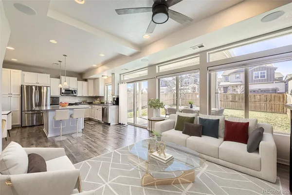 a living room with fireplace furniture and a large window