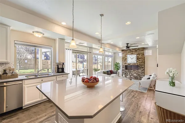 a very nice looking dining room with kitchen island furniture a large window and stainless steel appliances