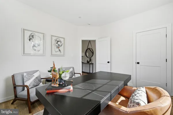 a living room with furniture and painting on the wall