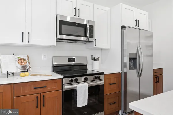 a kitchen with stainless steel appliances a refrigerator stove and microwave