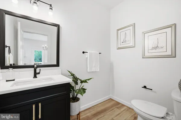 a bathroom with a sink a toilet and mirror