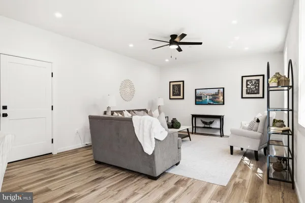 a living room with furniture and a wooden floor