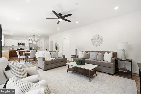 a living room with furniture and kitchen view