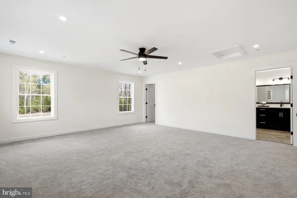 a view of a livingroom with a ceiling fan and window