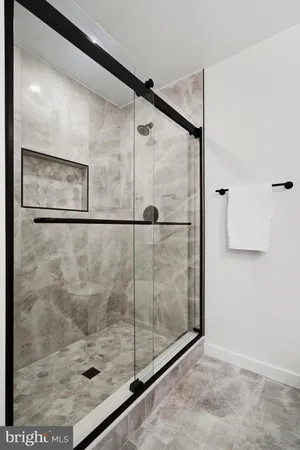 a bathroom with a glass shower door