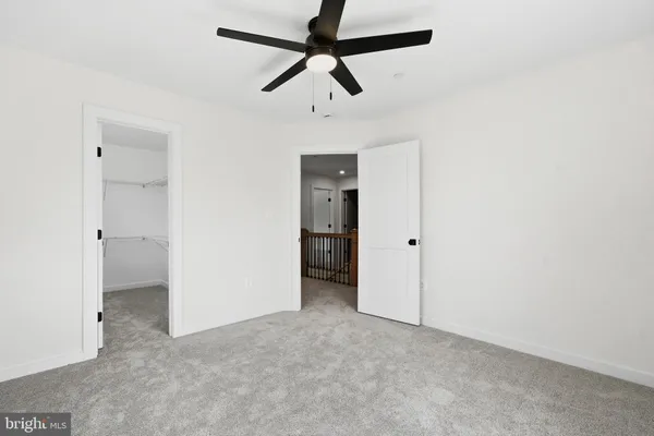 a view of a livingroom with a ceiling fan and entryway