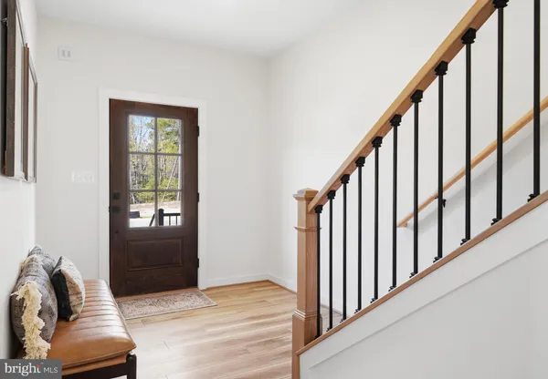a view of entryway and hall with wooden floor