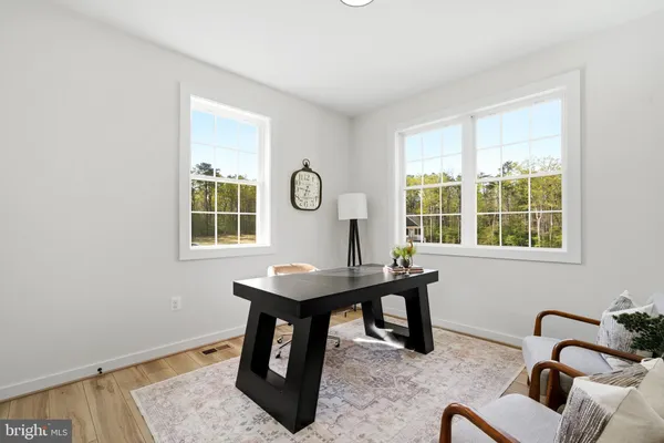 a view of a workspace with furniture and window