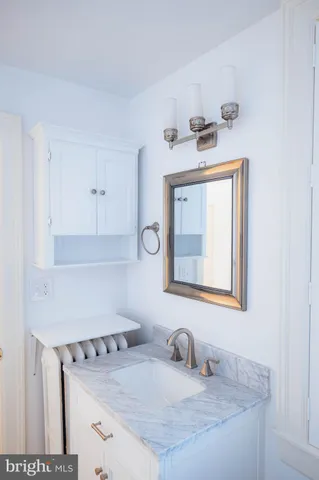 a bathroom with a sink a vanity and mirror