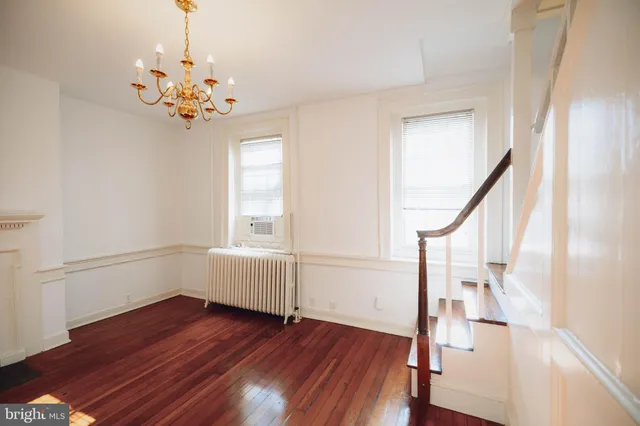 a view of an room with wooden floor and front door