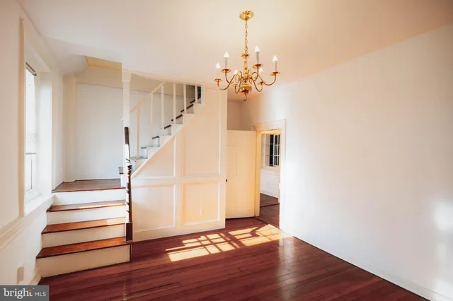 a view of a room with wooden floor and staircase