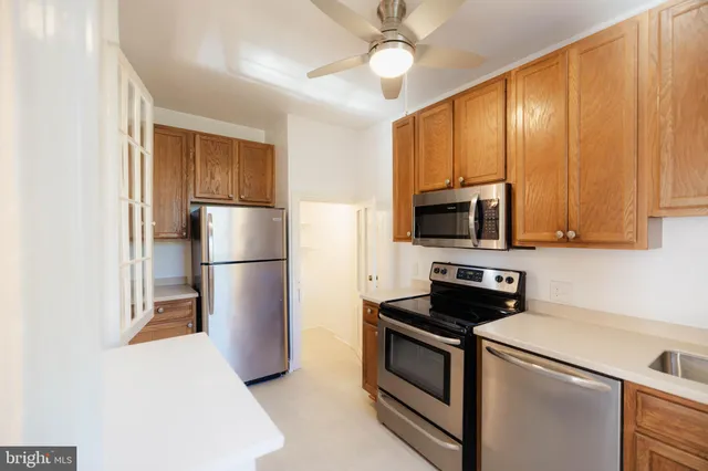 a kitchen with stainless steel appliances a refrigerator stove and microwave