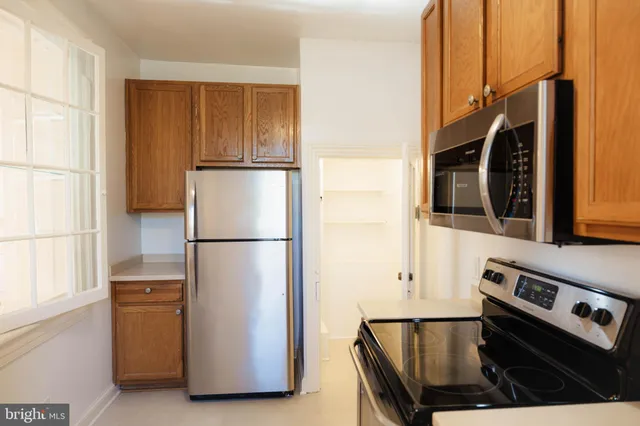 a kitchen with a refrigerator and a stove