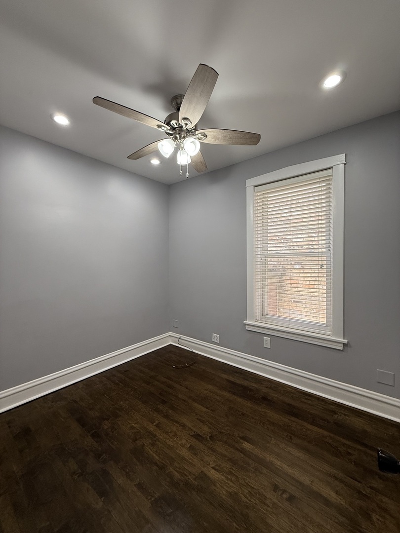 3721 West Belden Avenue, Unit 1 Chicago, IL 60647 - Photo 14 of 23 a view of an empty room with wooden floor and a window