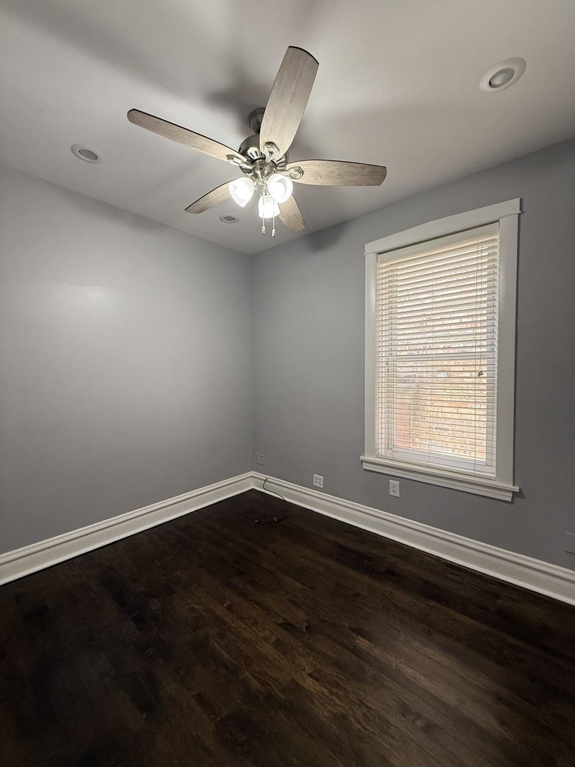 3721 West Belden Avenue, Unit 1 Chicago, IL 60647 - Photo 15 of 23 a view of an empty room with wooden floor and a window