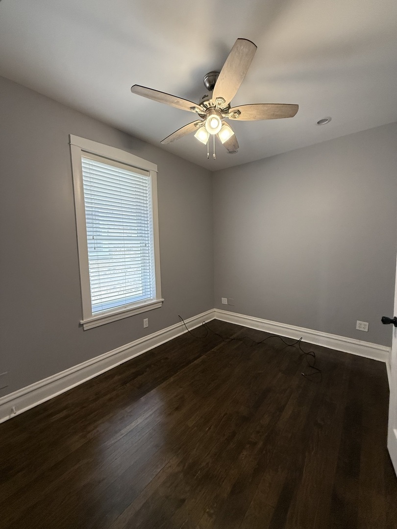 3721 West Belden Avenue, Unit 1 Chicago, IL 60647 - Photo 17 of 23 a view of an empty room with wooden floor and a window