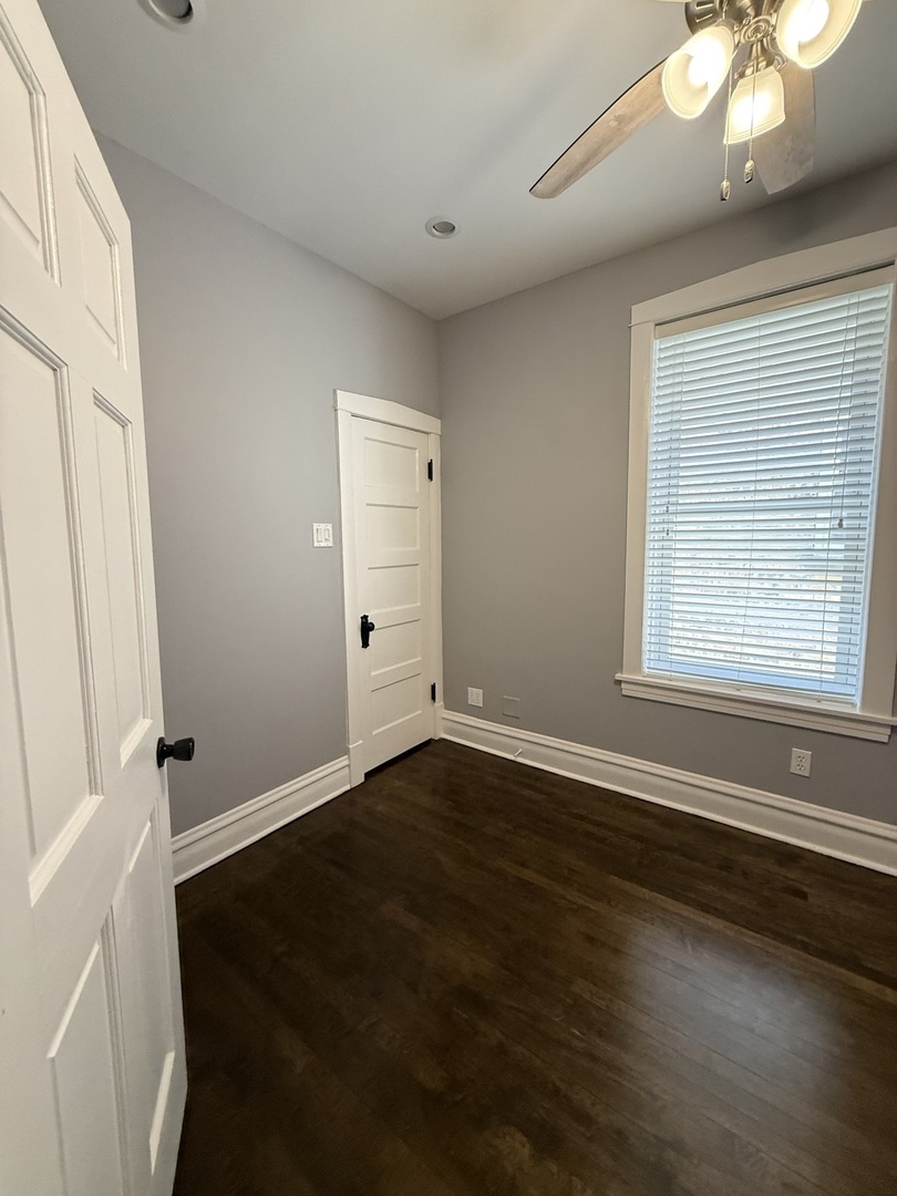 3721 West Belden Avenue, Unit 1 Chicago, IL 60647 - Photo 18 of 23 an empty room with wooden floor and windows