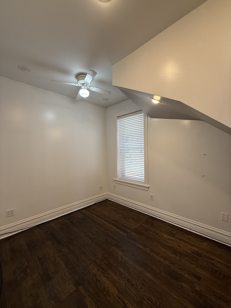 3721 West Belden Avenue, Unit 1 Chicago, IL 60647 - Photo 21 of 23 an empty room with wooden floor and fan
