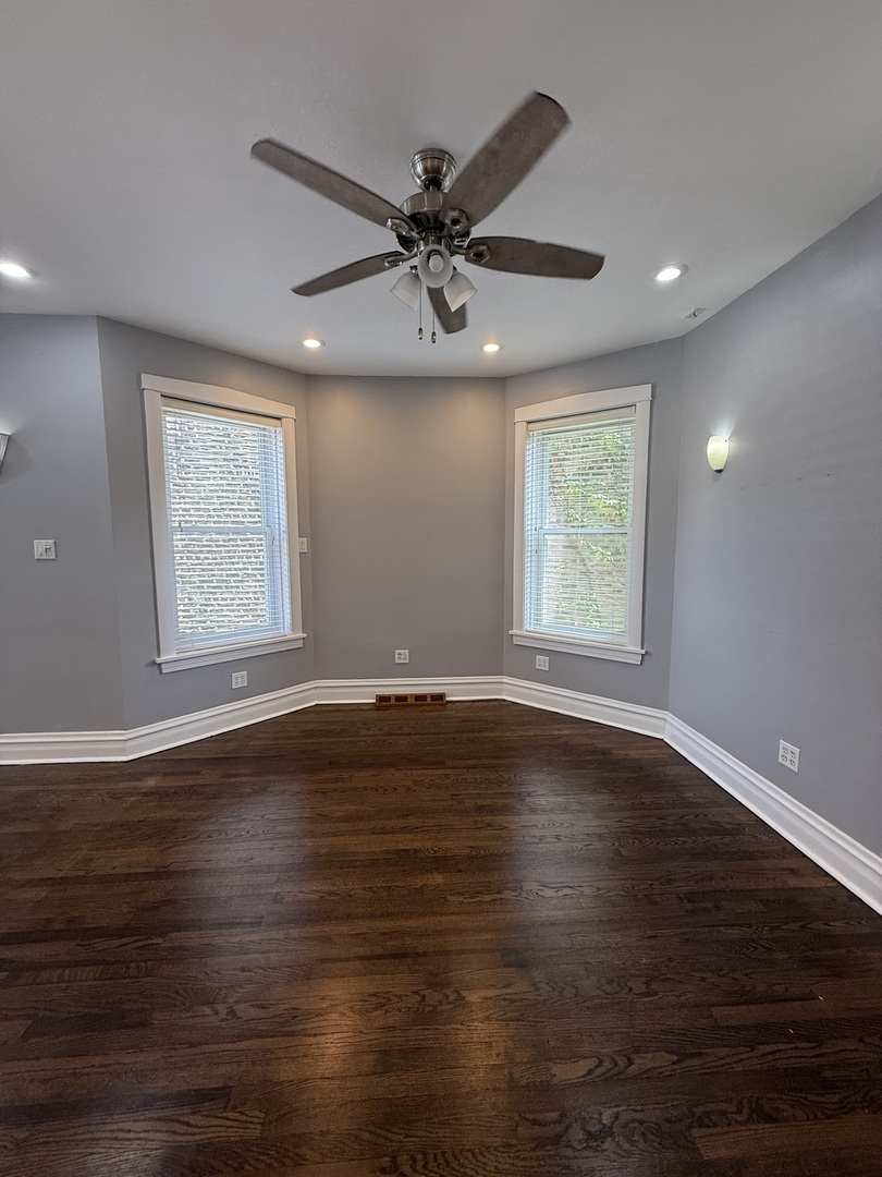 3721 West Belden Avenue, Unit 1 Chicago, IL 60647 - Photo 23 of 23 an empty room with wooden floor windows and ceiling fan